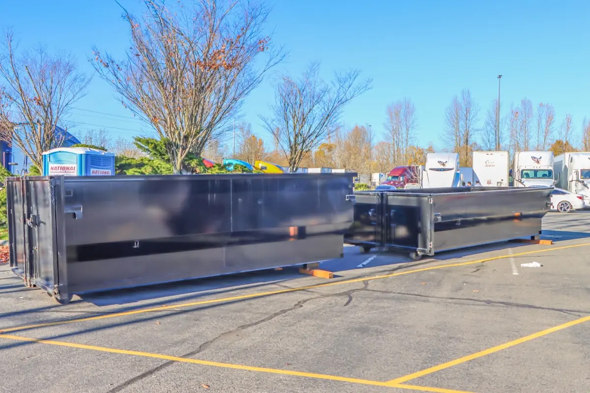 Professional dumpster rental service with roll-off container on residential driveway in Fort Hood